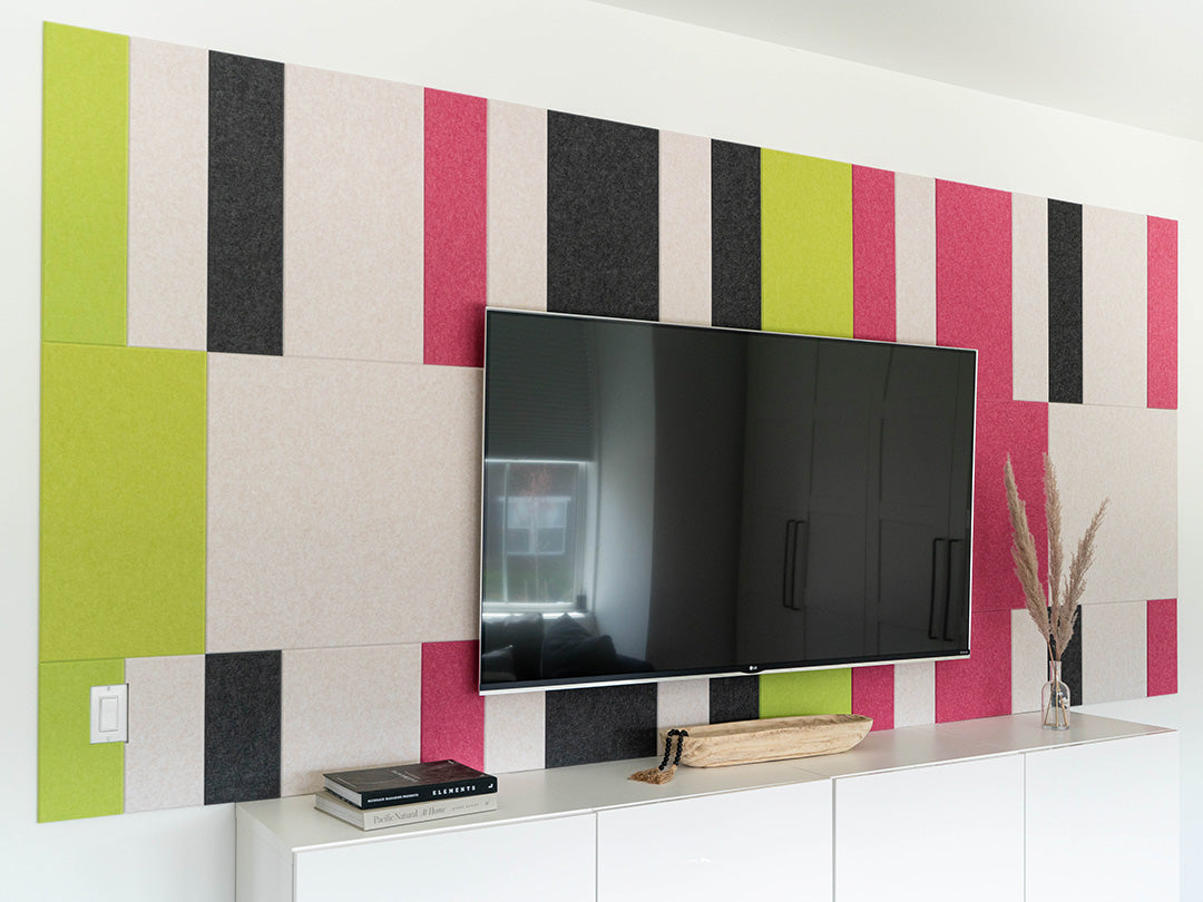 Pink and green wall art behind Tv