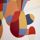 Abstract geometric wall art featuring overlapping organic shapes in terracotta red, mustard yellow, slate blue, tan, and cream on a white background.