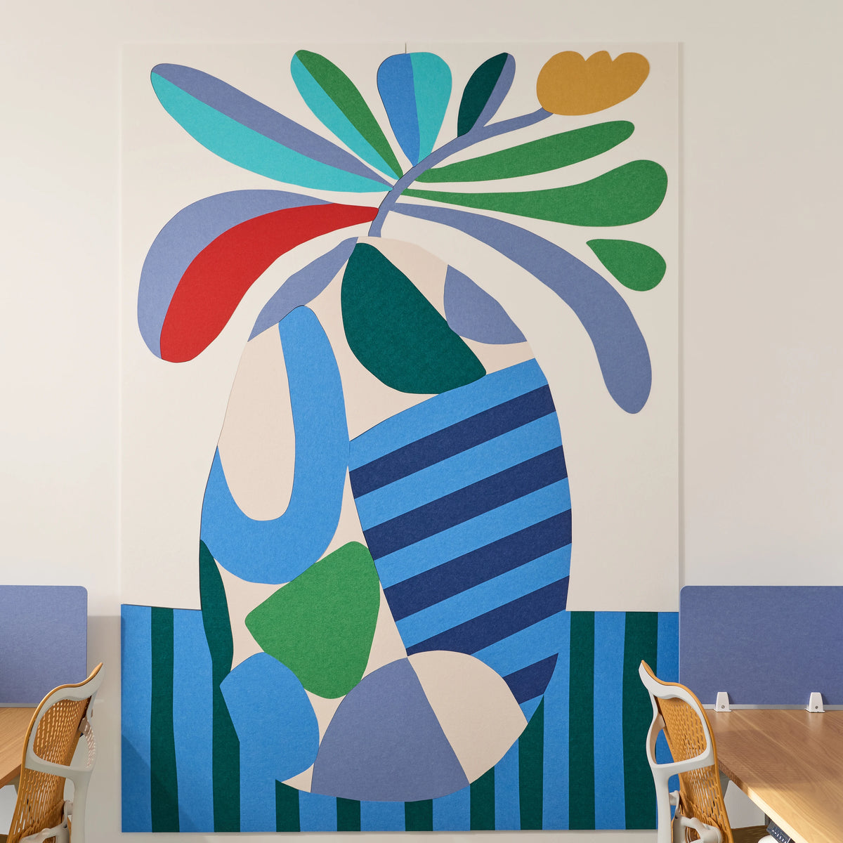 Large abstract floral wall art installed on a white wall in a modern office or meeting room setting, with blue paneling, chairs, and a wooden table visible at the bottom.