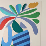 Abstract wall art featuring layered organic shapes in green, blue, navy, red, teal, and mustard yellow on a white background.