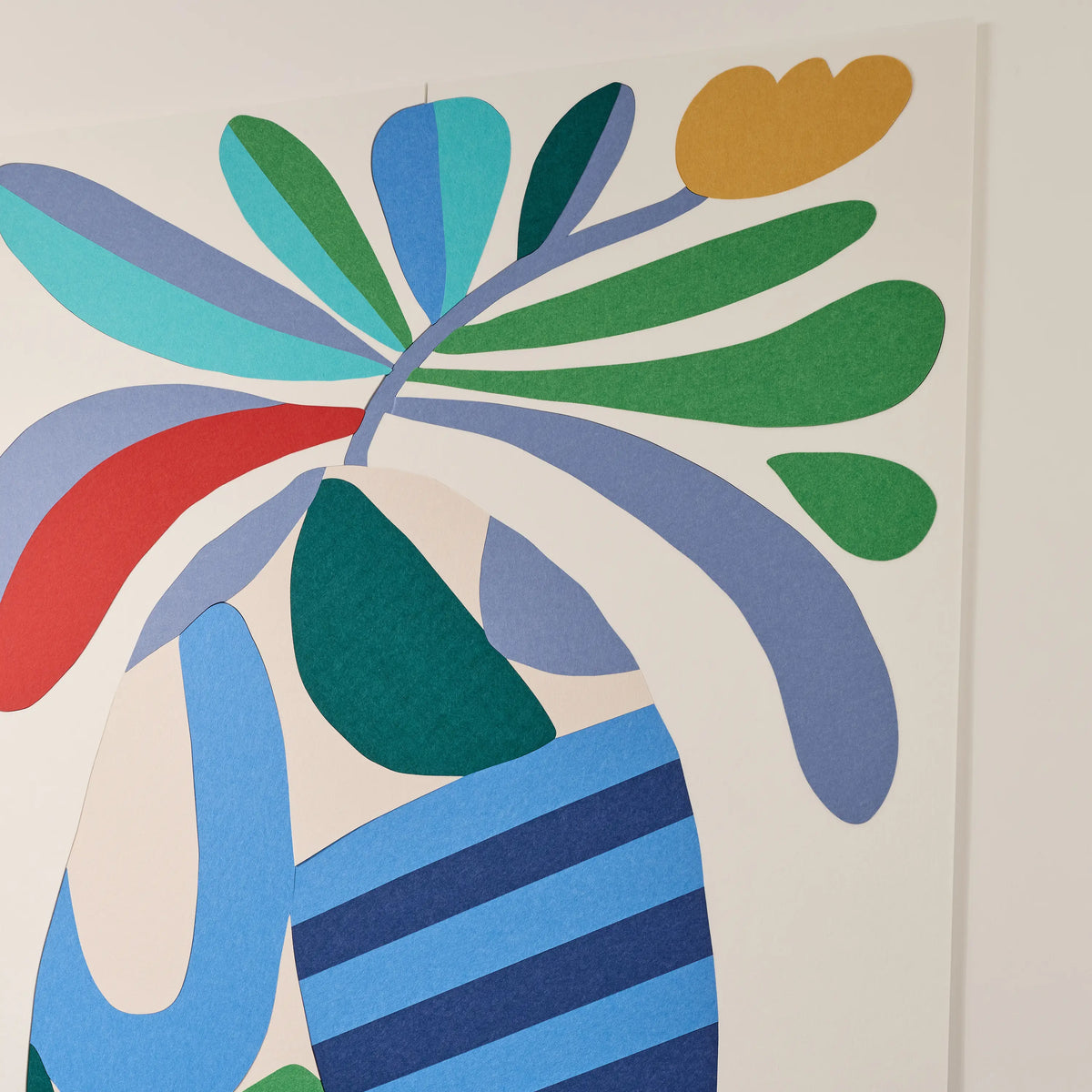Abstract wall art featuring layered organic shapes in green, blue, navy, red, teal, and mustard yellow on a white background.