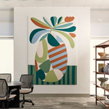 Large abstract acoustic wall art that is installed on a white office wall above a meeting table. The artwork features bold, organic shapes in teal, green, orange, cream, and light blue, with striped and solid patterns.