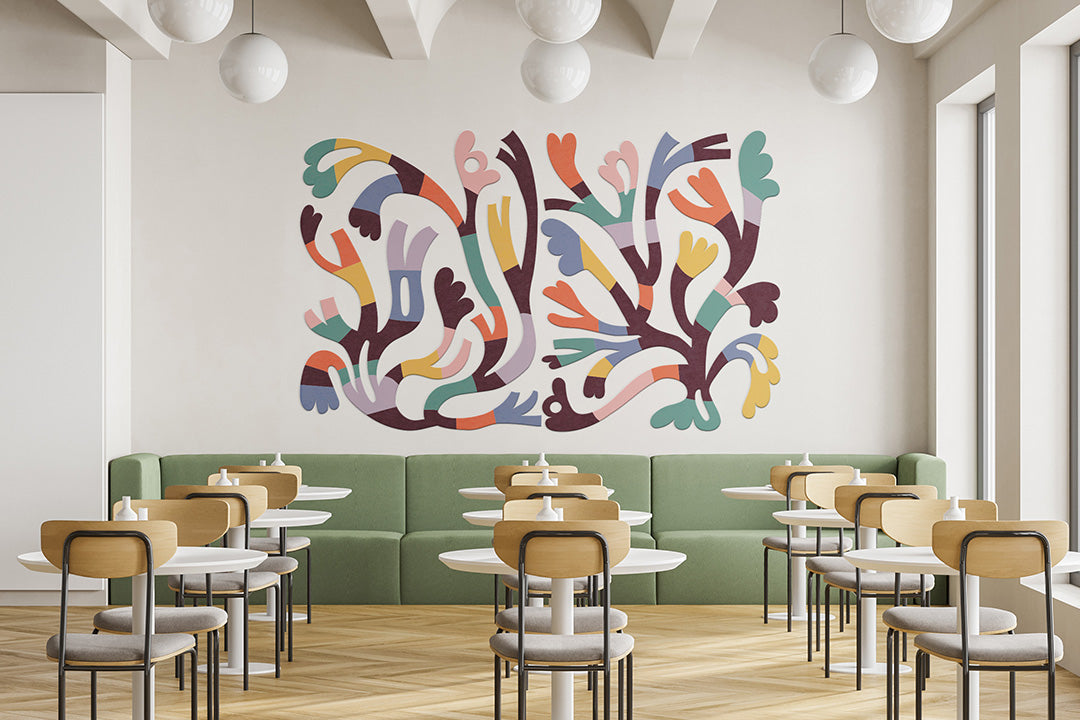 Modern restaurant interior with colorful wall art and green booth seating.