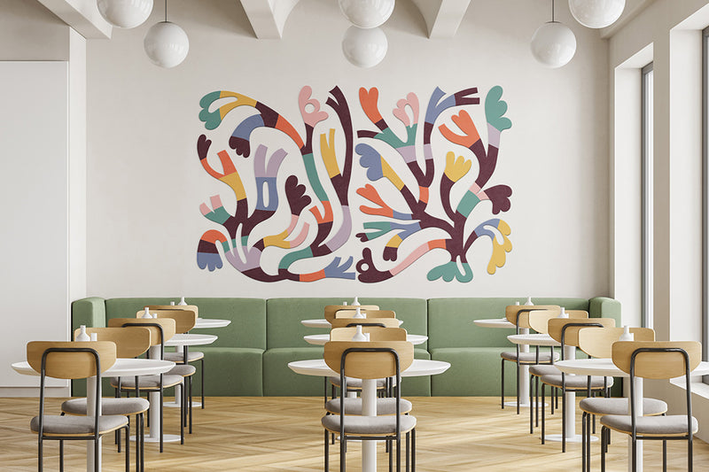 Modern restaurant interior with colorful wall art and green booth seating.