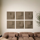 Brown acoustic felt tiles with peak designs above a brown couch