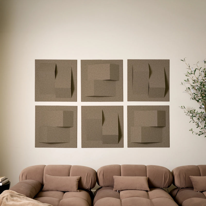 Brown acoustic felt tiles with peak designs above a brown couch