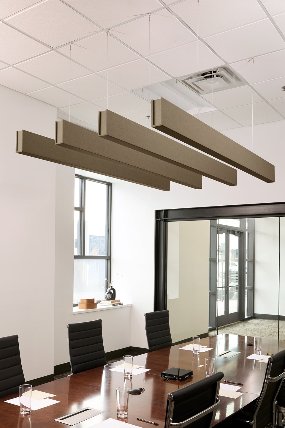 PET felt suspended acoustic beam in Timber by Felt Right absorbs unwanted noise and looks great in any setting. Available in four or eight foot lengths. Clips into ACT grid or drills into drywall ceiling.