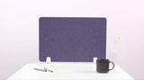 Purple desk divider with curved topographic lines on white desk legs, next to pens, mug, and vase.