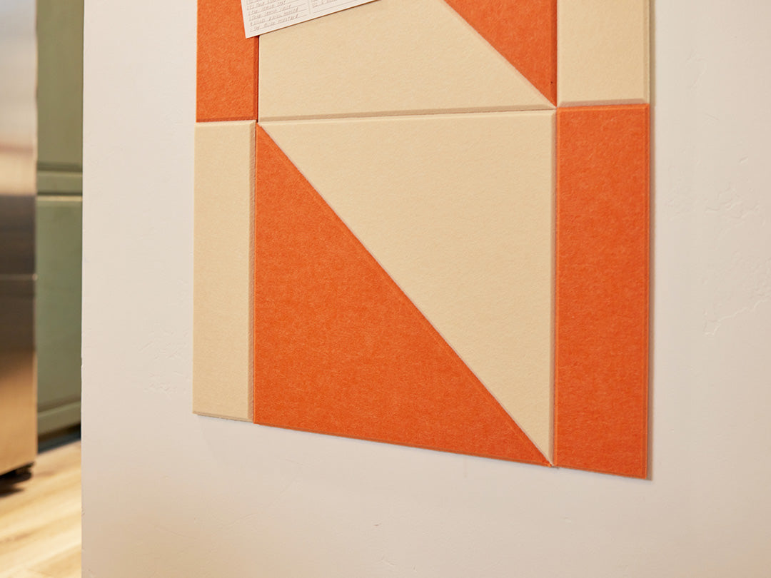 Felt Right tiles in shades of orange and cream in a twist pattern on a wall
