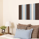 Bedroom with striped wall art above the bed