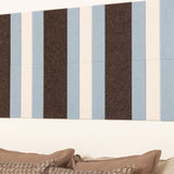 Striped headboard with brown, blue, and white vertical stripes on a white wall.
