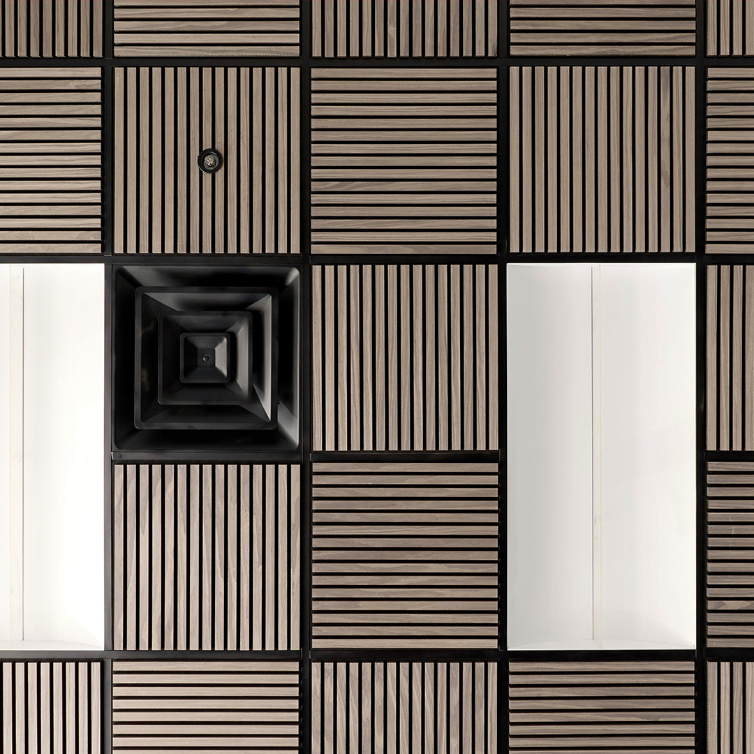 A modern geometric wall panel design featuring a grid of square tiles with alternating solid dark wood-grain panels and slatted panels in dark brown and black.