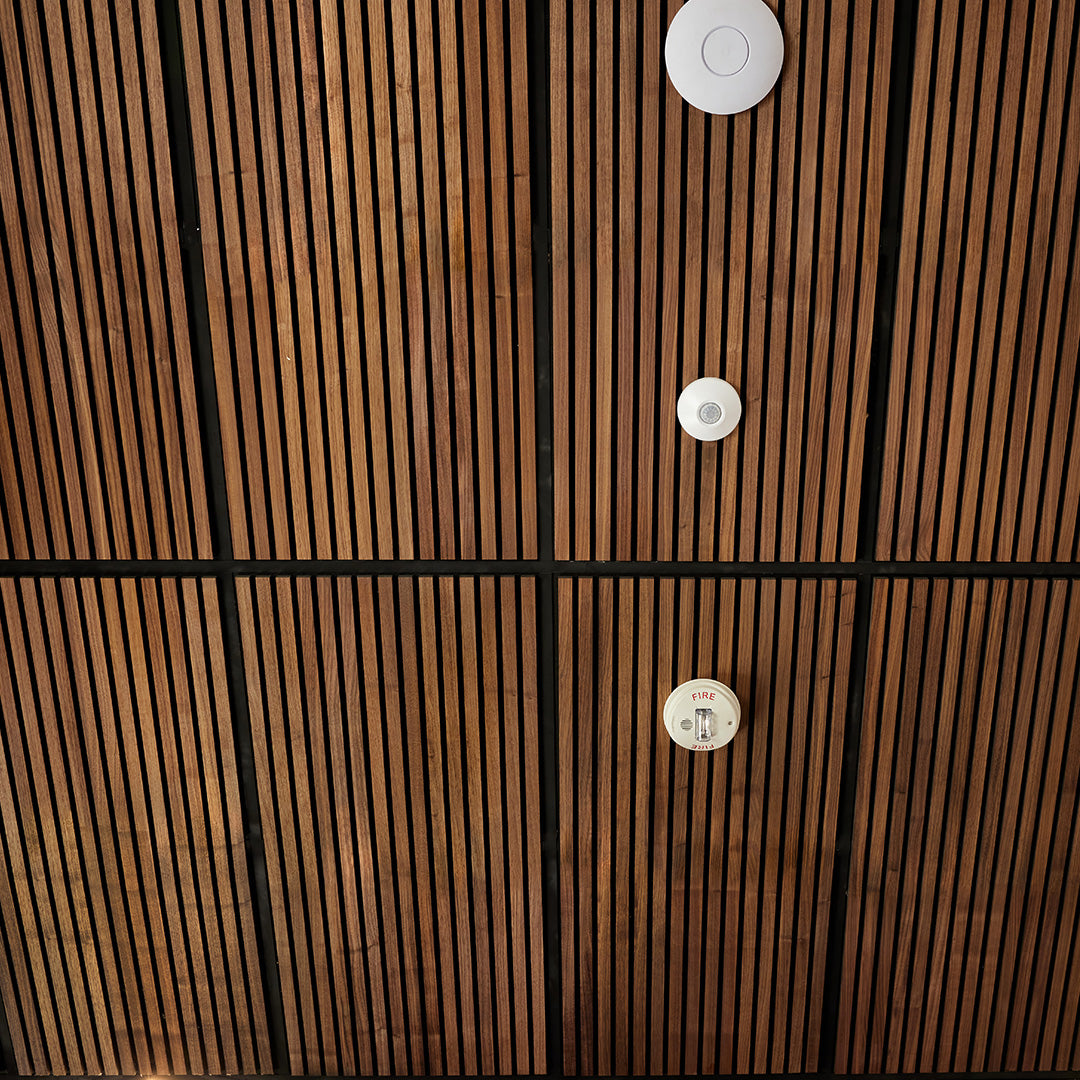 Wooden panel with circular cutouts and visible brand label