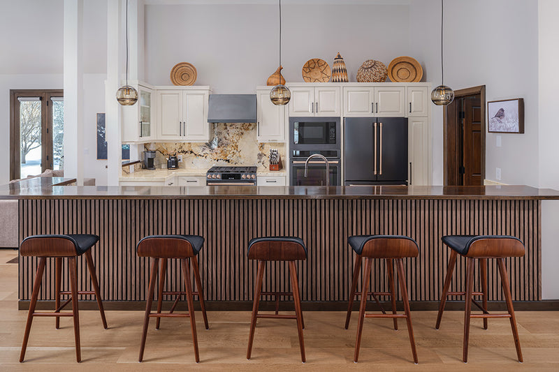 Walnut wood slatted wainscoting under kitchen bar with stools.