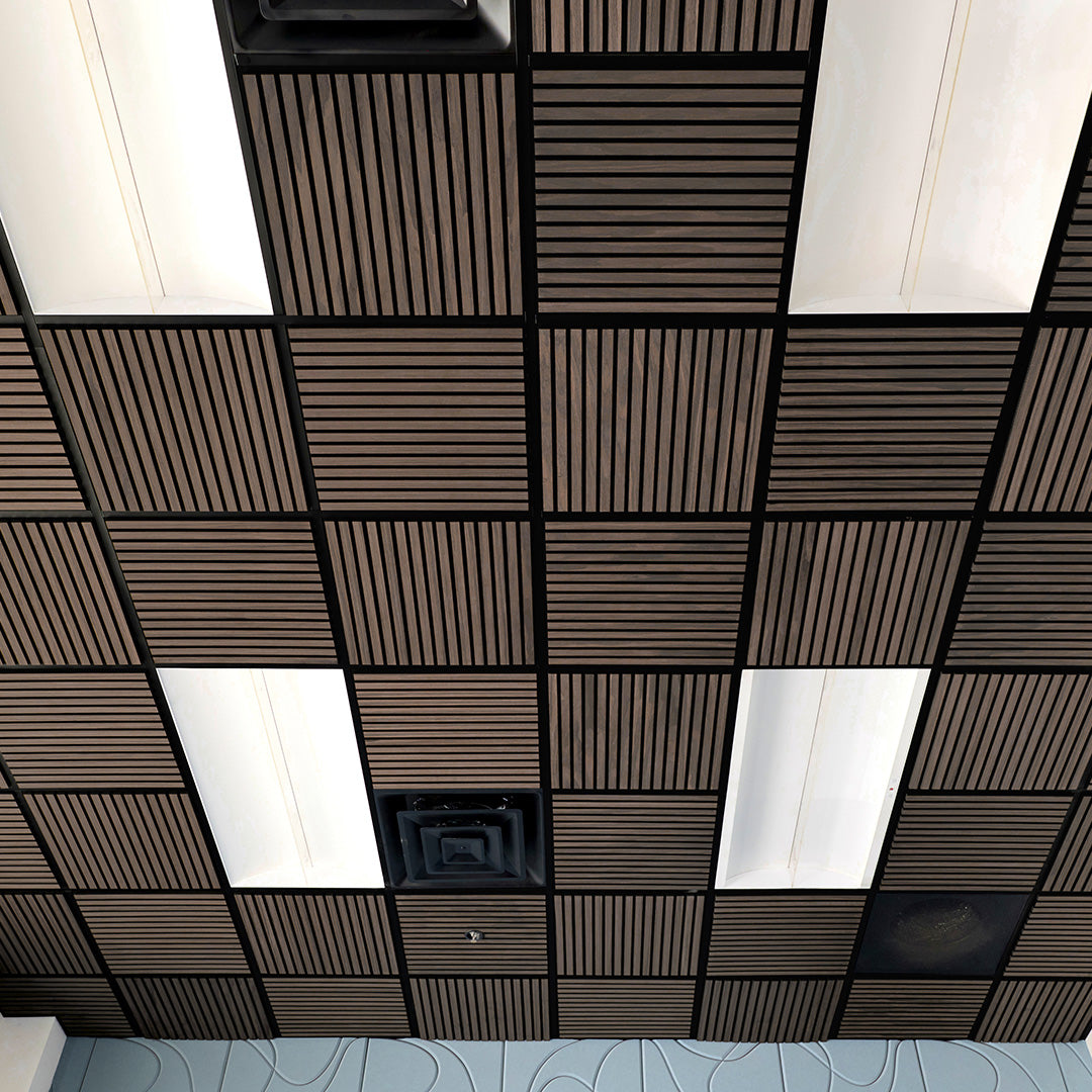 A ceiling grid of square acoustic tiles, featuring alternating dark brown slatted panels and white rectangular panels, with a black metal frame throughout.