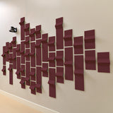 Dark red acoustic felt tiles with points that resemble peaks along a wall