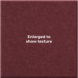 A close-up of a burgundy textured material with the centered text 'Enlarged to show texture' in white.