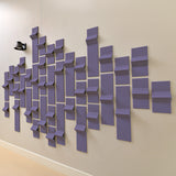 Soft purple felt acoustic tiles along a wall with a hallway light