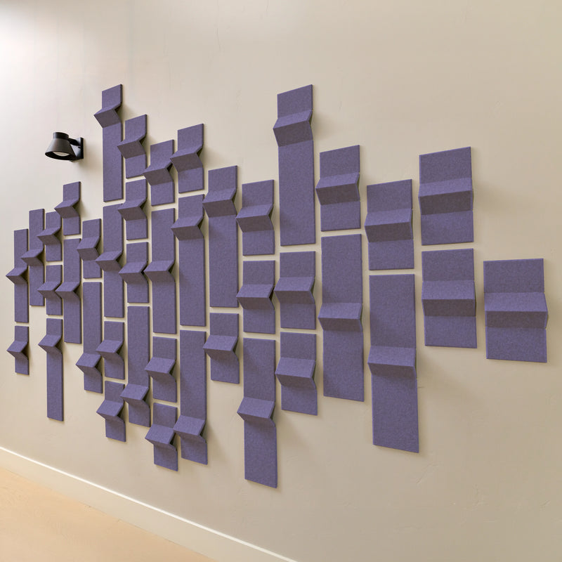 Soft purple felt acoustic tiles along a wall with a hallway light