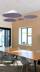 Purple elliptical ceiling baffles suspended above a conference table in a modern office space with wooden wall paneling.