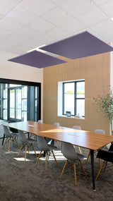 Two dark blue square acoustic panels suspended from white ceiling grid above conference table.