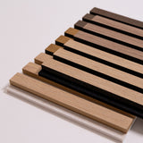 A stack of rectangular wood slats samples in multiple natural wood tones, including light tan, medium brown, and dark brown, arranged on a plain light background.