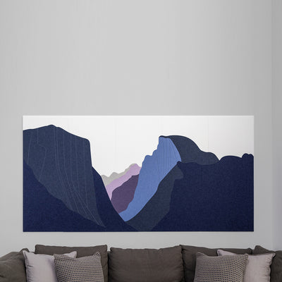Abstract wall art with blue and purple shapes on a gray wall above a sofa.
