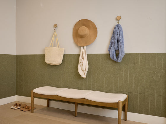 Olive green wainscoting with vertical ribbed texture covering lower half of white wall in room setting.