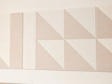 A Felt Right wall art design in shades of cream felt tiles on a wall 