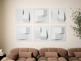 Set of six white dimensional tiles with geometric cube and rectangular shapes creating shadow effects on wall.