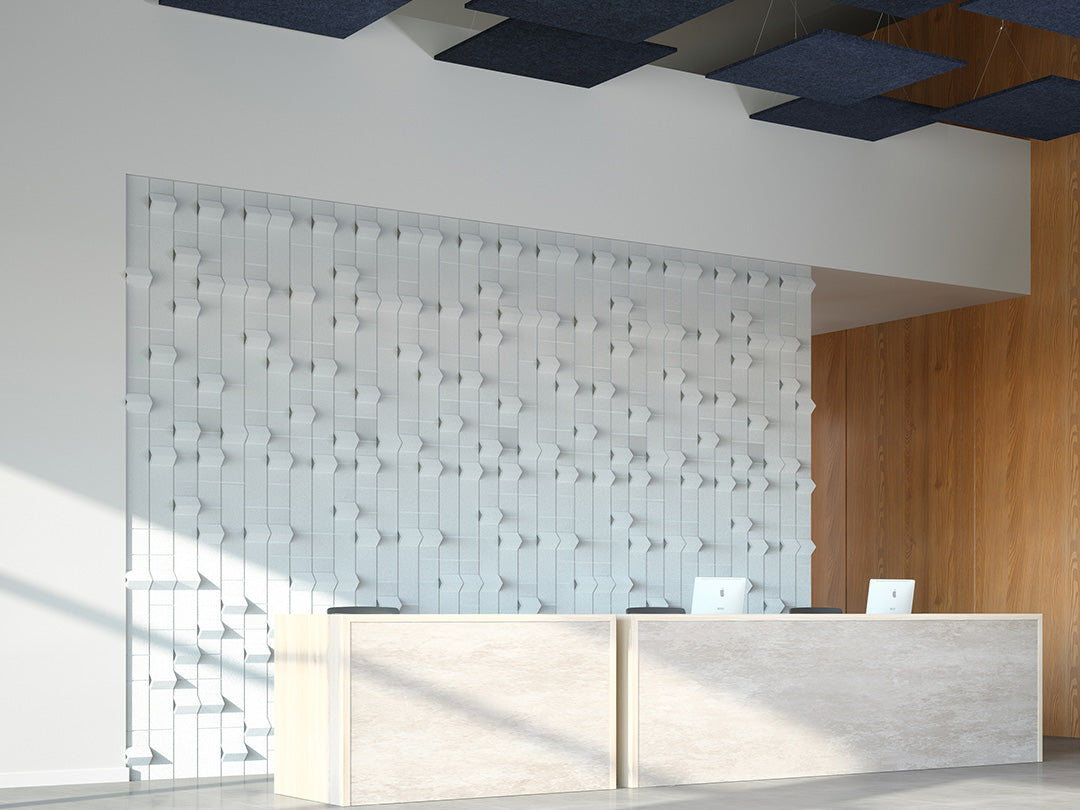 Modern interior design with a reception desk and textured acoustic wall.