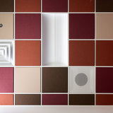 Colorblock felt drop ceiling tiles in burgundy, rust, cream and brown with a light fixture and air vents