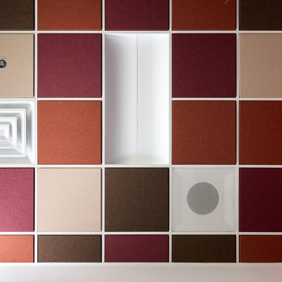 Colorblock felt drop ceiling tiles in burgundy, rust, cream and brown with a light fixture and air vents