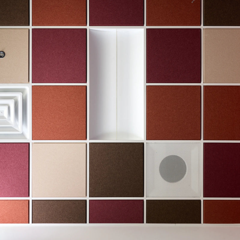 Colorblock felt drop ceiling tiles in burgundy, rust, cream and brown with a light fixture and air vents