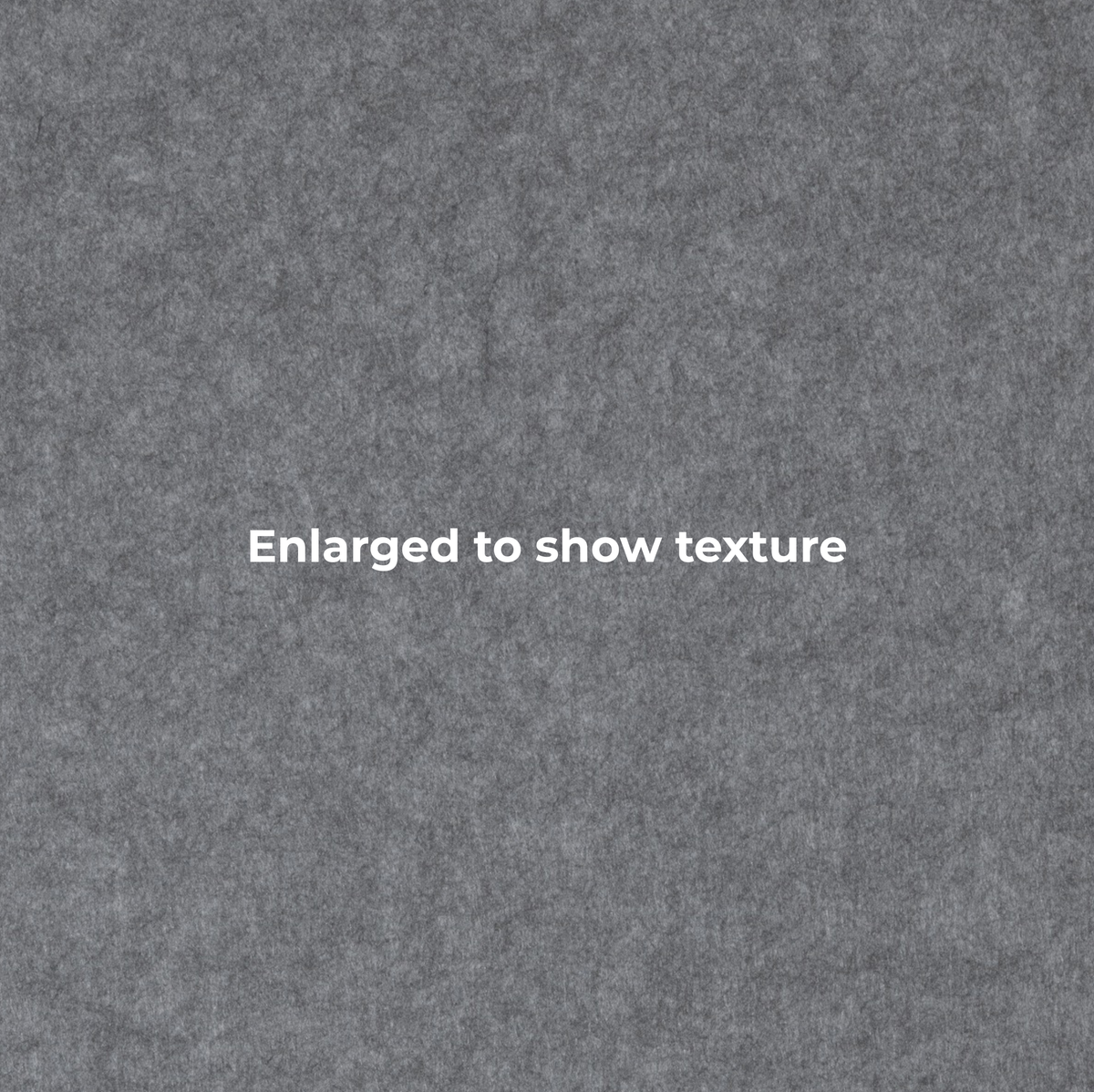 A close-up textured gray surface with the centered text 'Enlarged to show texture' in white.