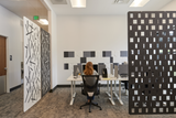 felt right felt tiles in shades of black and white along a white wall in an office with many desks