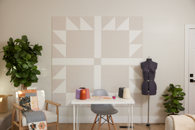 Felt Right Bears Paw quilt design wall in cream and white displayed in a bedroom or craft room