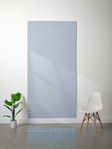 Blue felt sheet with engraved geometric pattern of vertical lines and curved quarter-circle designs across four sections.