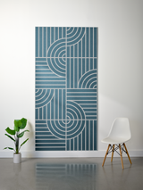 Teal felt sheet with engraved geometric pattern of curved and straight lines in layered design.