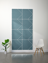 Teal felt sheet with engraved geometric chevron and diagonal line pattern arranged in symmetrical sections.