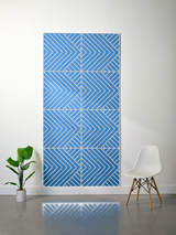 Blue felt sheet with engraved geometric chevron and diagonal line pattern in four sections.