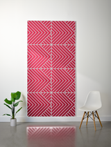 Red and white layered felt sheet with engraved geometric chevron and diagonal stripe pattern in converging sections.