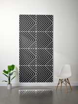 Black and white layered felt sheet with engraved geometric chevron and diagonal stripe pattern in four sections.