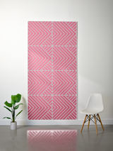 Pink felt sheet with engraved geometric chevron pattern in four sections, displayed on white wall.
