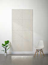 Rectangular felt sheet with engraved geometric chevron pattern in four sections, cream and gray tones.
