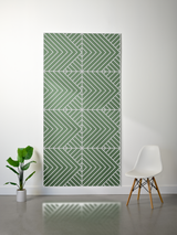 Green and white felt sheet with engraved geometric chevron and diagonal stripe pattern in repeating quadrants.