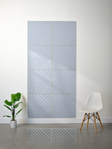 Blue-gray felt sheet with engraved chevron and diagonal line patterns arranged in eight square tiles.