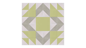 Felt Right Mother's Favorite in Aloe quilt design wall in light greens and cream displayed in a bedroom or craft room