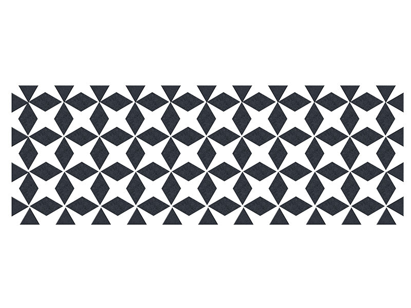 Cast iron trivet with dark gray geometric origami-inspired pattern on white background.