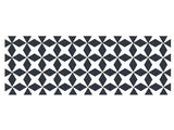 Cast iron trivet with dark gray geometric origami-inspired pattern on white background.